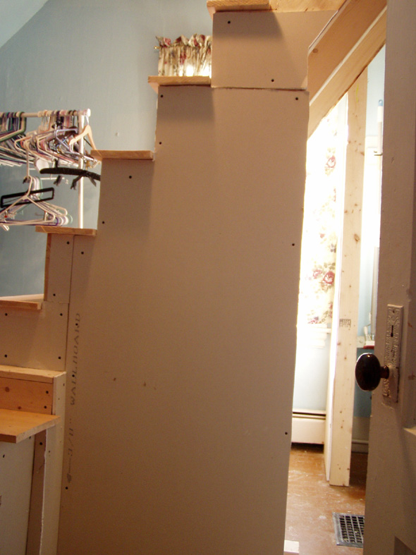 We've added some drywall to the side of the stairs. Eventually we'll have shelving beneath it.