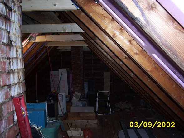 Just another view of the south side of the attic, minus the lower crossbeams.  Except for the clutter, it's a lot easier getting around up here now.