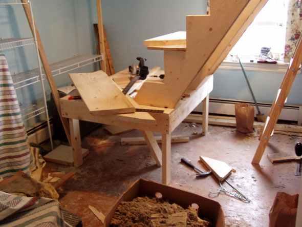 The anticipated problem with access to the stairs is solved with a platform at the base of the stairs. There will, of course, be steps leading to the platform.
