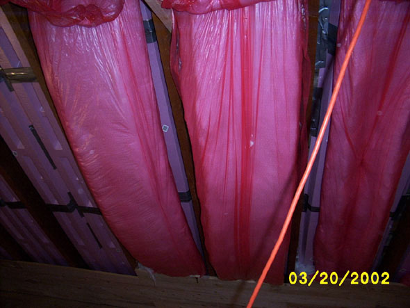 I've found that it's easier to begin boarding in the bottom of the wall before hanging the insulation lest it get in the way of the work.