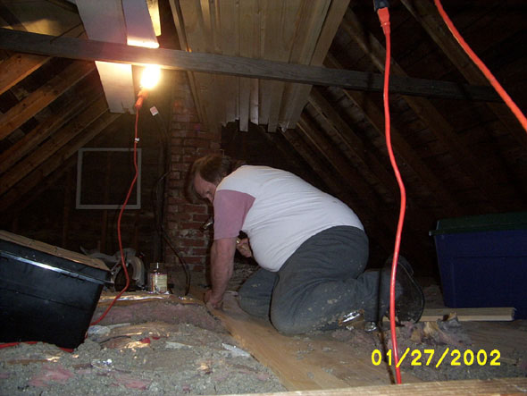 Now that it's been cut to fit around the chimney, I'm nailing it into place.