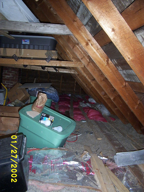 Looking south along the north side of the attic.  Until I finally bought some impact-resistant bulbs, I was blowing a light bulb everytime I jostled the light cord.