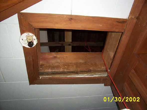 This is currently the only way into the attic, as seen from a vantage point near the landing of the stairs and the upstairs kitchen.