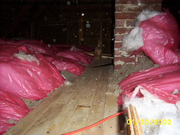 With a good stretch of floor in place on the north side, I've extended it toward the south, laying it on top of some rolls of insulation.
