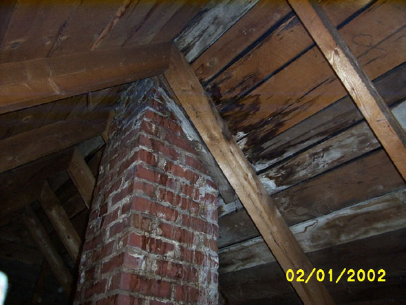 Now that I have a floor that will permit me to get closer to it without a risk to life, I can get a clearer look at the roofing issues that will have to be dealt with this spring.  The wood is still good but, as you can see, it is wet -- and water stains can be seen along the outside of the chimney.