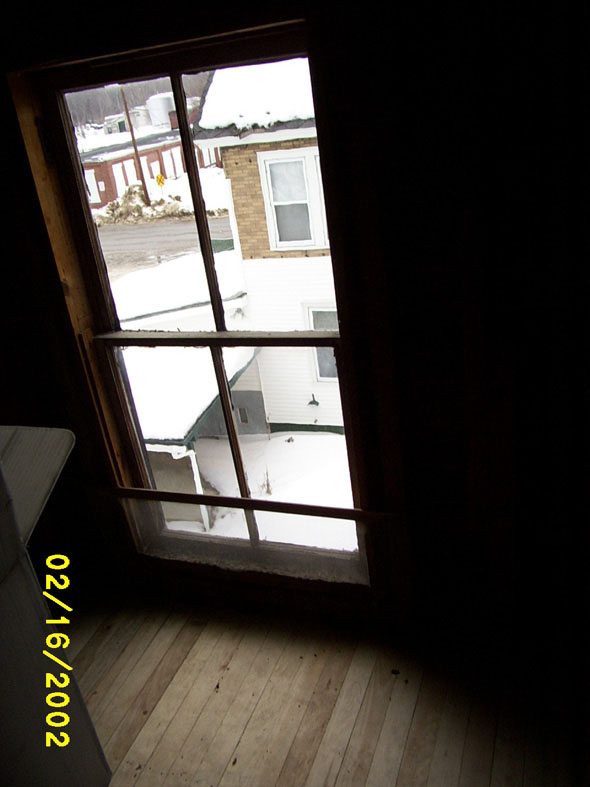 The brown house that can be seen through the north window has been vacant for years.  It's expected to go up for tax sale soon, and we're hoping to be able to buy it.  It has absolutely no yard, so there may be few if any other bidders.  Being next door to us, that won't be a problem.