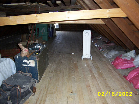 I get the feeling that the crossbeams were never intended to provide structural support.  They were obviously added at some point well after the house was built, and you can see that they were put in almost haphazardly.  I think they were intended simply to provide a place to store stuff, there having been no floor until I put one in.