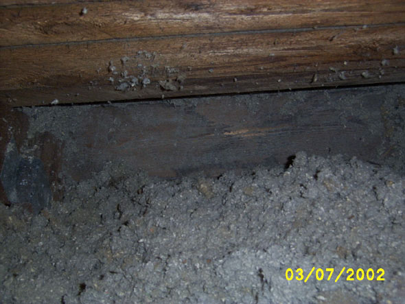 Just zooming in on the same picture as above.  The gap that you can see above the blocking board is larger than it appears in the photograph, and the air feels cooler than the air in the attic, so perhaps there will be some circulation of cool air.