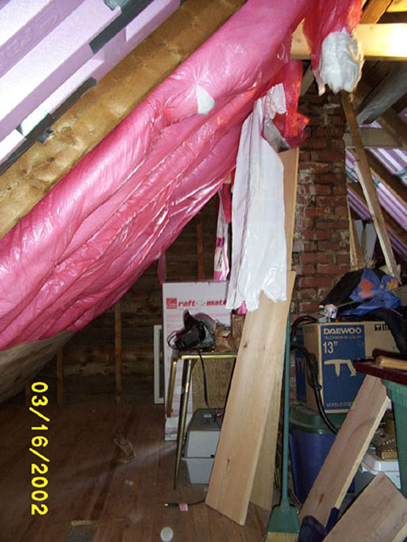 The rolls of insulation cover most of the space between rafters, the remainder to be taken up with loose insulation.