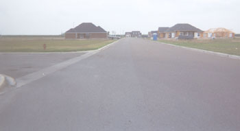 After sitting empty for a year, we are seeing some houses being built along Retama Street at Plaza Central, west of the new First National Bank building.