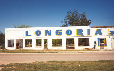 Despite the fact that all but the east portion of the building is a shell, Longorias is not an abandoned building.  It appears to house an auto repair shop.