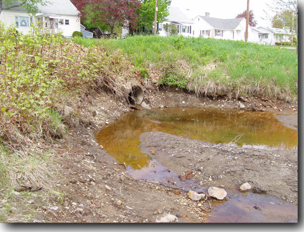 Storm drain carrying reddish, smelly water into Millinocket Stream.
